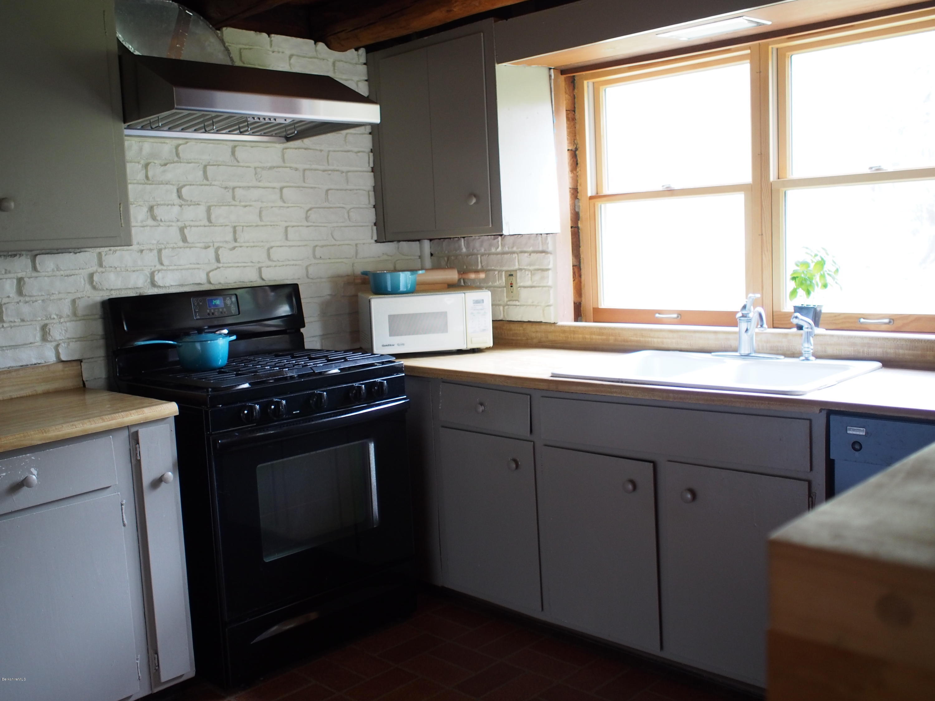 52 Central Shaft Road Florida, MA 01247 - Photo 12 of 31 a kitchen with a sink stove top oven and cabinets