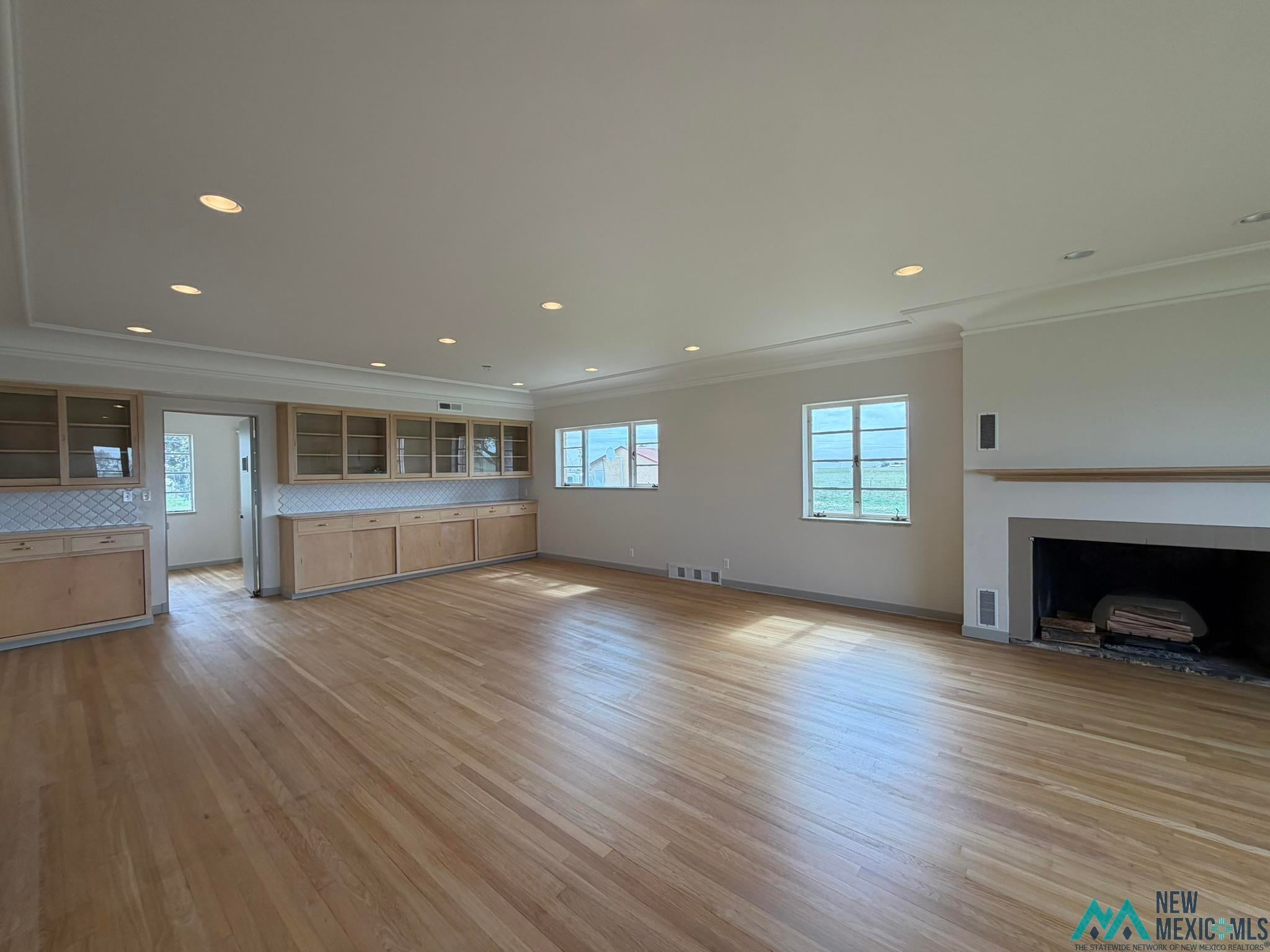 570 Curry Road North Clovis, NM 88101 - Photo 12 of 59 Spacious room featuring wood-finish flooring, recessed lighting, and crown molding