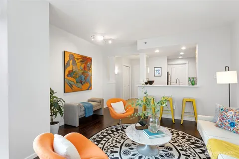 a living room with furniture a fireplace and next to a window