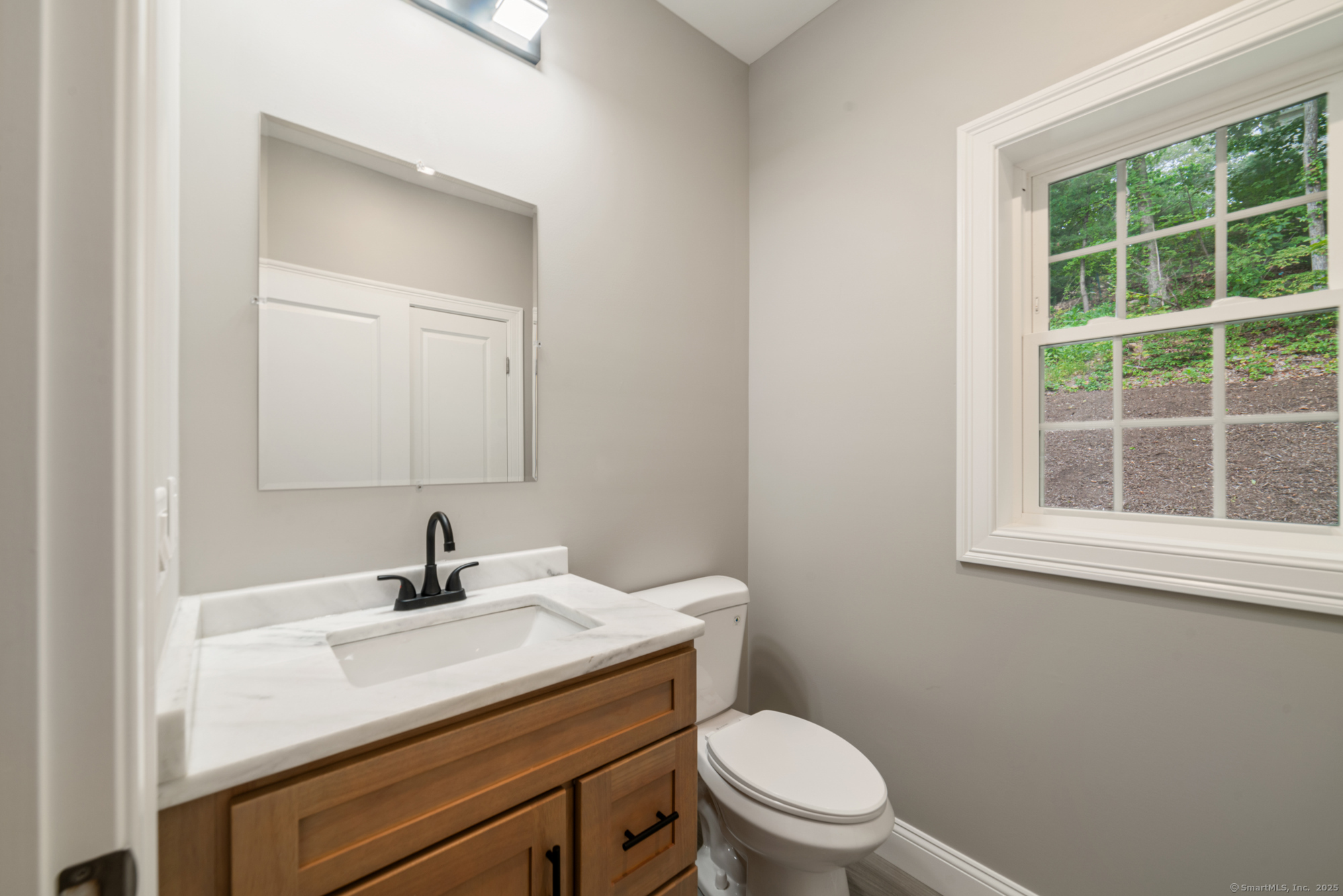 164 Fox Den Road Bristol, CT 06010 - Photo 14 of 40 a bathroom with a sink a toilet and a window