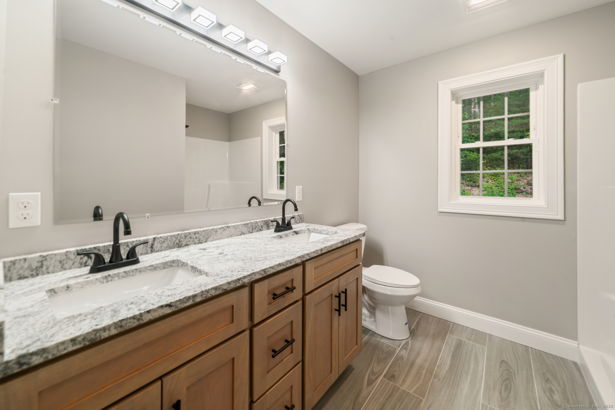 164 Fox Den Road Bristol, CT 06010 - Photo 28 of 40 a bathroom with a granite countertop sink a toilet and a mirror