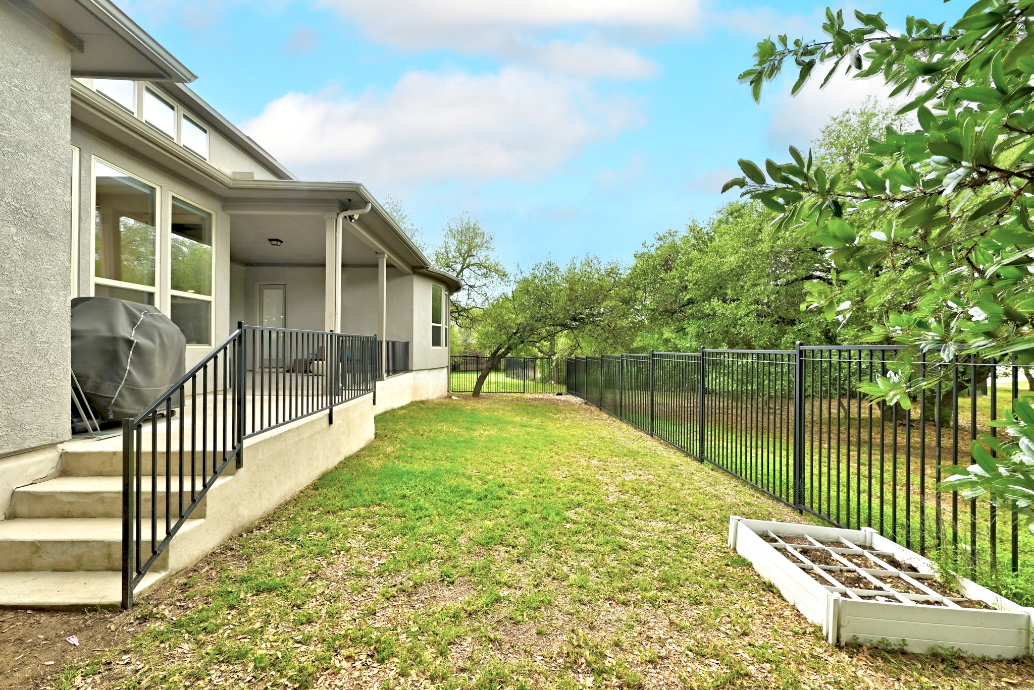 9008 Harper Rae Drive Austin, TX 78717 - Photo 38 of 39 Covered patio with exterior lighting and a concrete stairway featuring black wrought iron railings