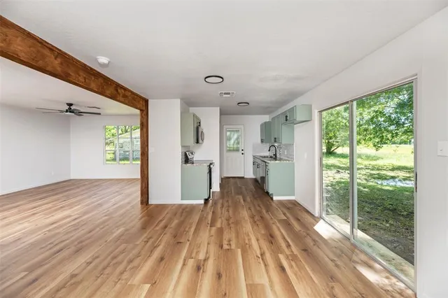 a view of a living room hardwood floor to ceiling window and wooden floor