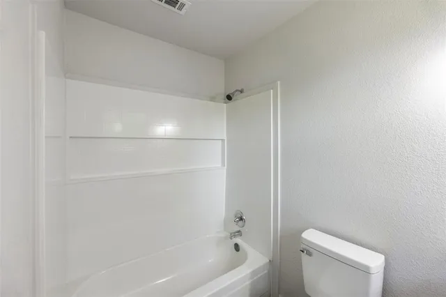a bathroom with a shower and a toilet