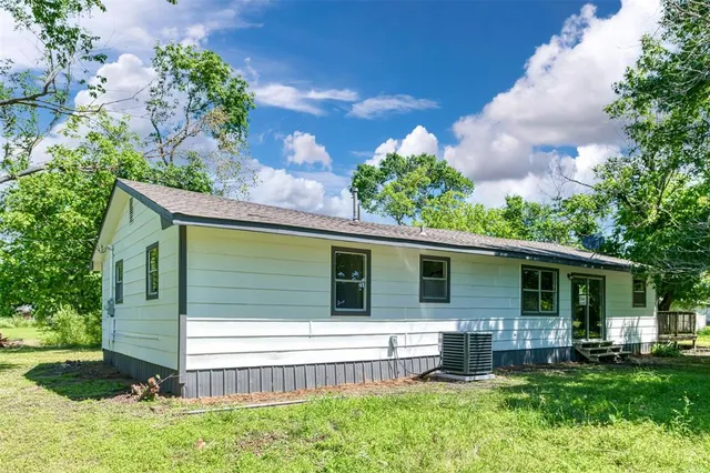 a view of a house with a yard and sitting area