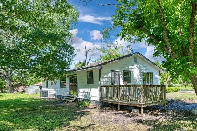 a front view of a house with a garden and plants