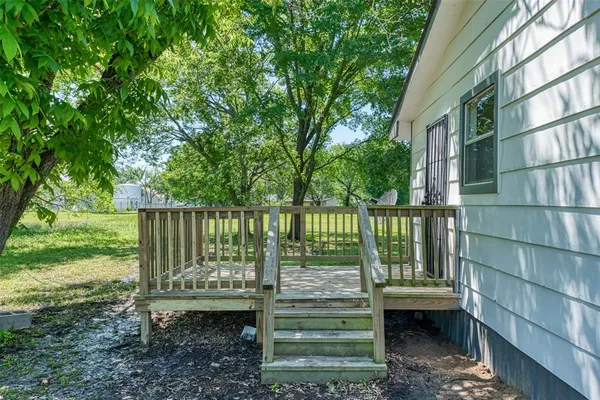a view of a wooden deck and a yard