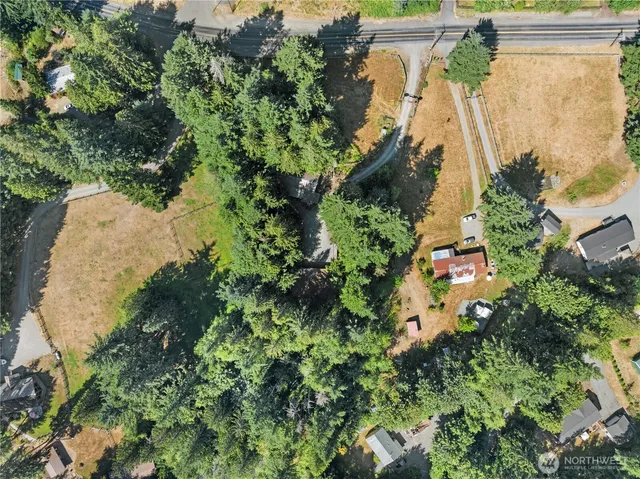 an aerial view of a house with a yard basket ball court and outdoor seating