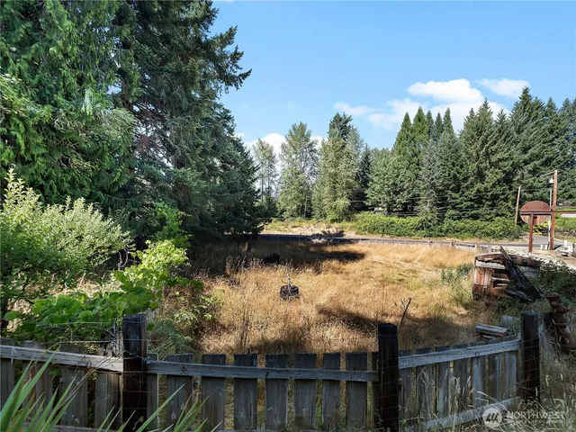 a view of a backyard with sitting area