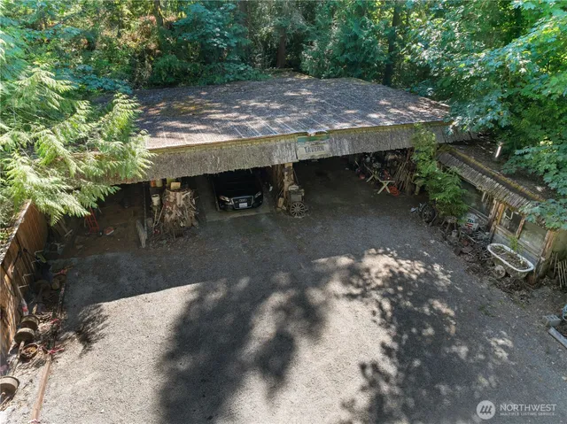 a view of a wooden floor with some trees in the background