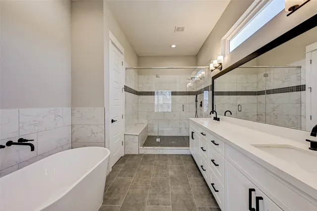 a bathroom with a tub sink and mirror