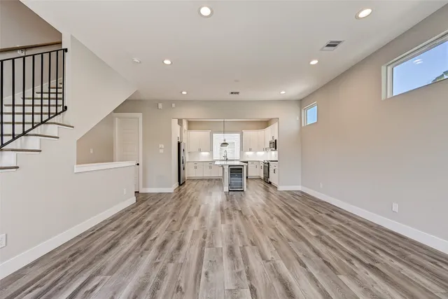 a view of empty room with wooden floor