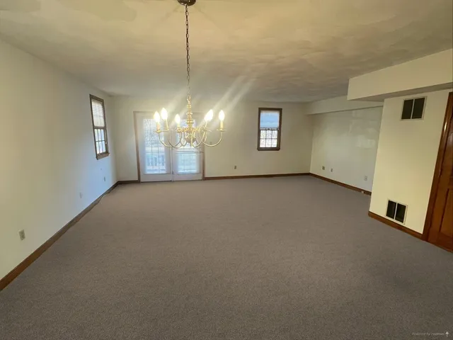 a view of a room with a windows and ceiling fan