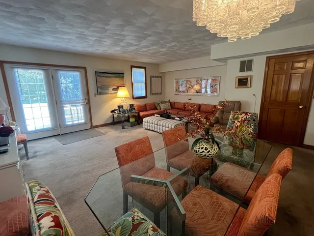 a living room with furniture two window and a flat screen tv