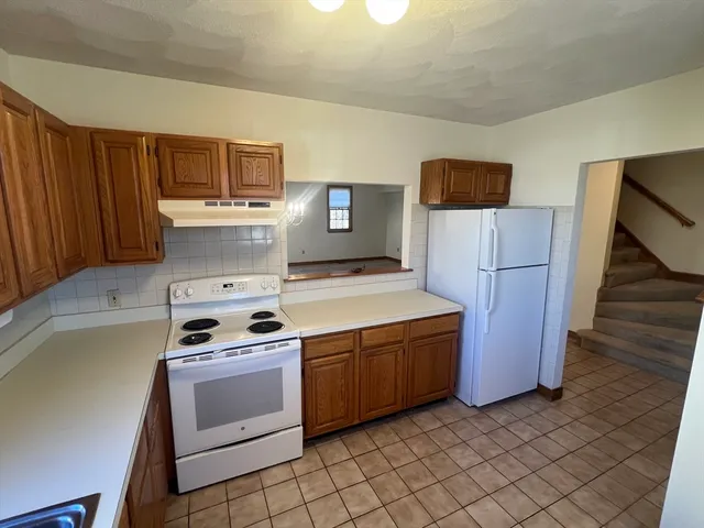 a kitchen with a stove and a refrigerator