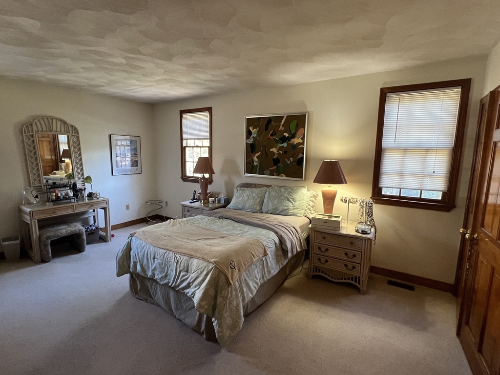 1050 Chestnut Street, Unit 1050 Newton, MA 02464 - Photo 7 of 15 a bedroom with a bed and a dresser