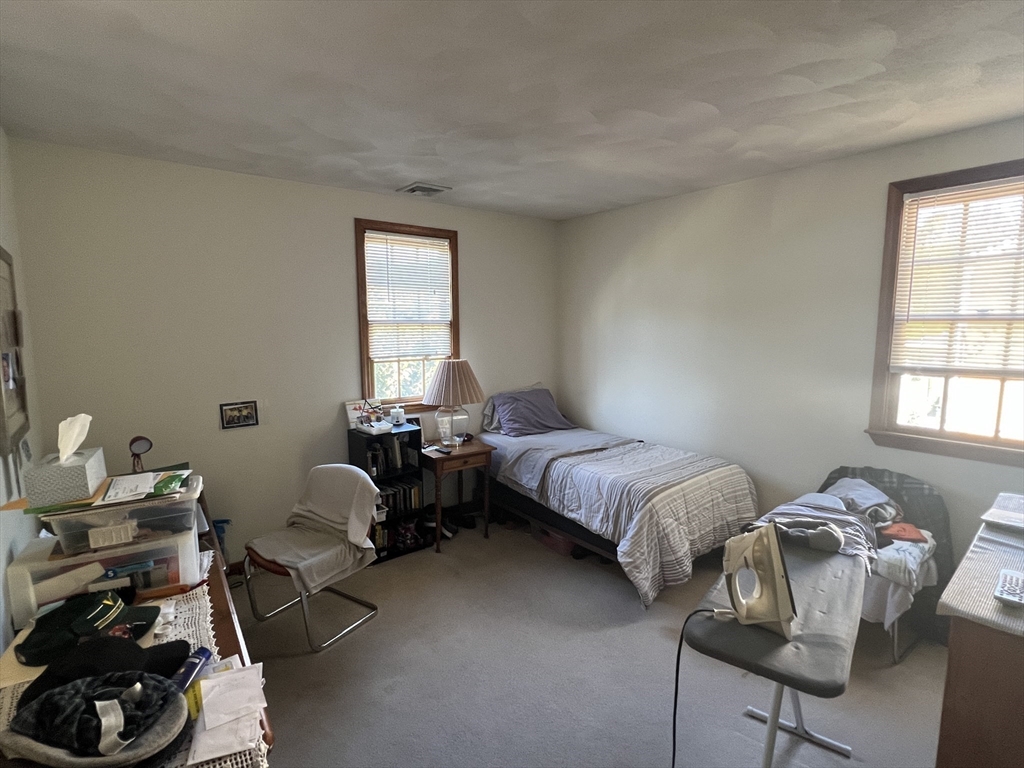 1050 Chestnut Street, Unit 1050 Newton, MA 02464 - Photo 10 of 15 a bedroom with bed chair and window