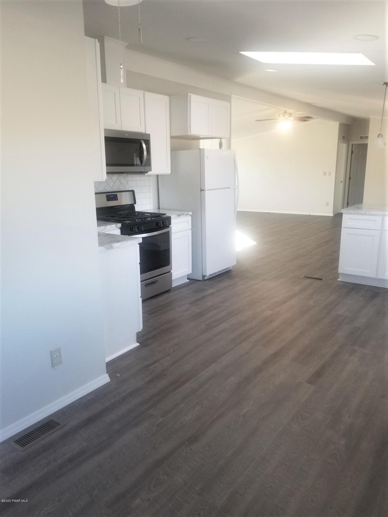 3361 North Reed Road Chino Valley, AZ 86323 - Photo 11 of 29 a kitchen with a refrigerator and a stove top oven