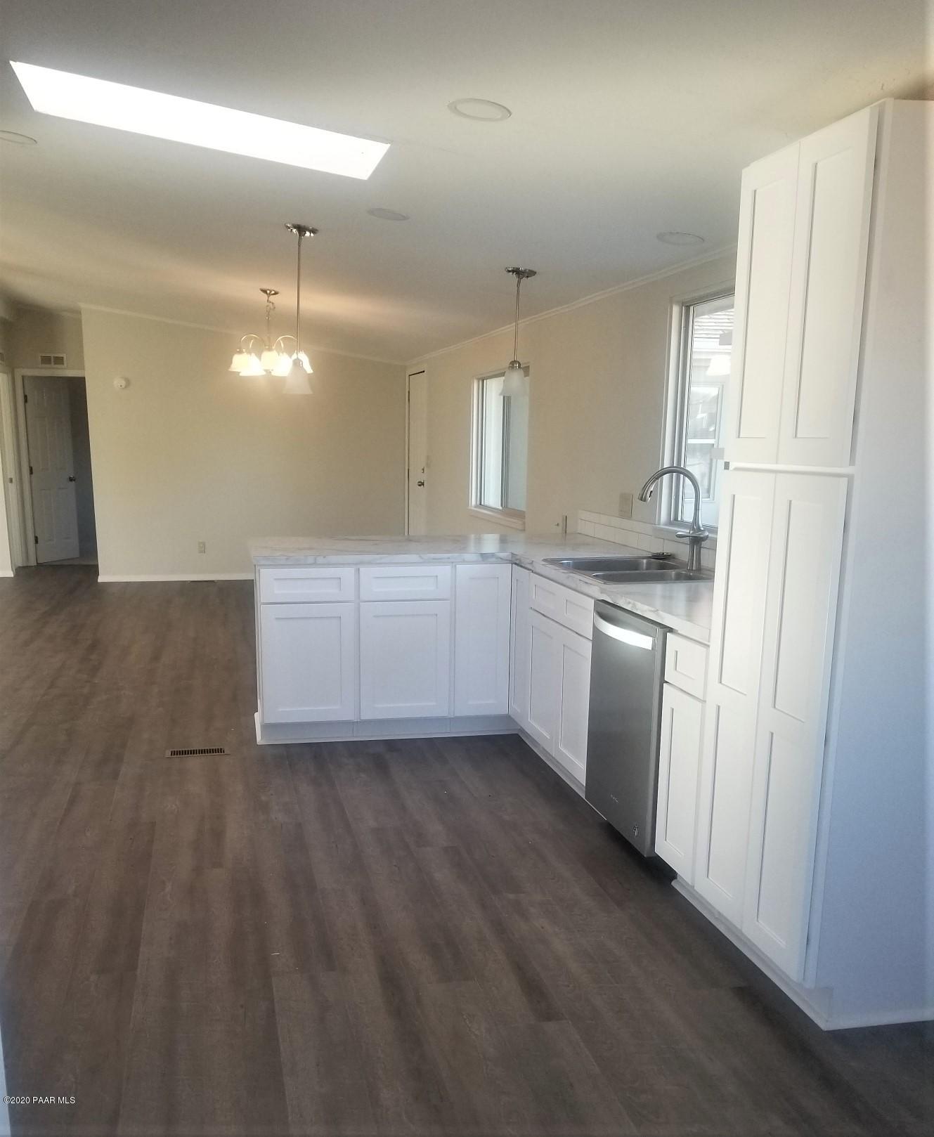 3361 North Reed Road Chino Valley, AZ 86323 - Photo 12 of 29 a kitchen with white cabinets and white appliances