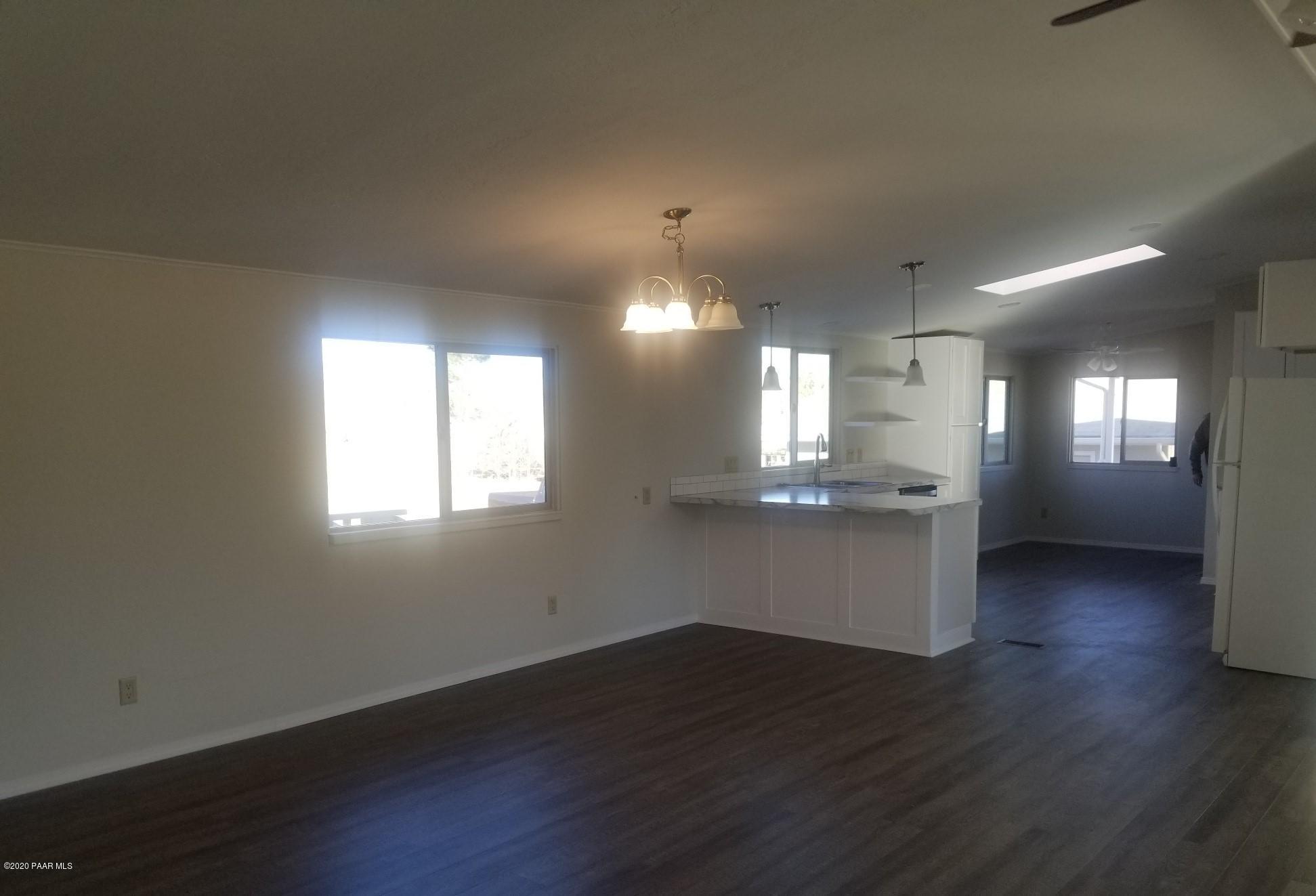3361 North Reed Road Chino Valley, AZ 86323 - Photo 16 of 29 an empty room with wooden floor and windows