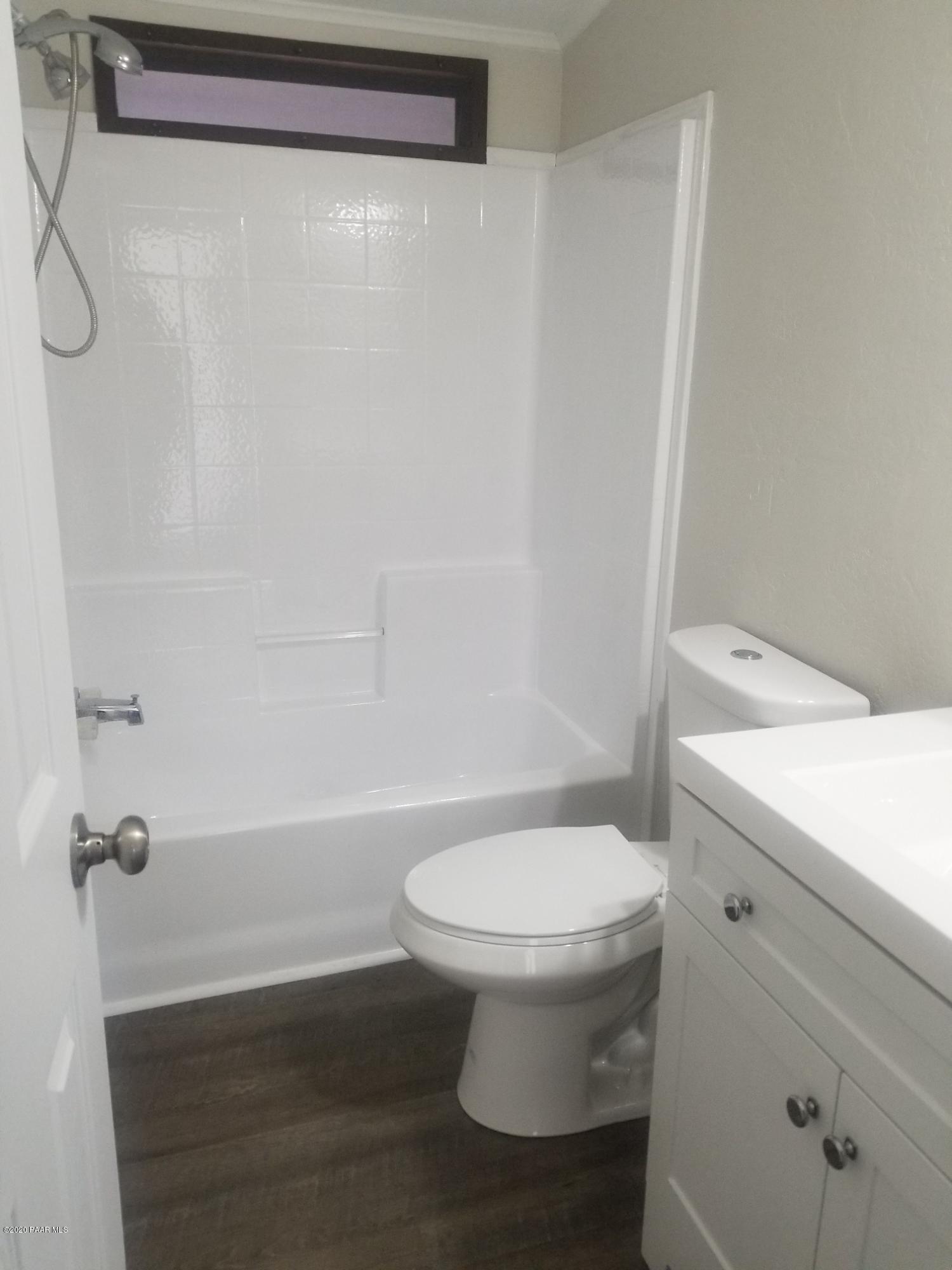 3361 North Reed Road Chino Valley, AZ 86323 - Photo 18 of 29 a white toilet sitting next to a bath tub