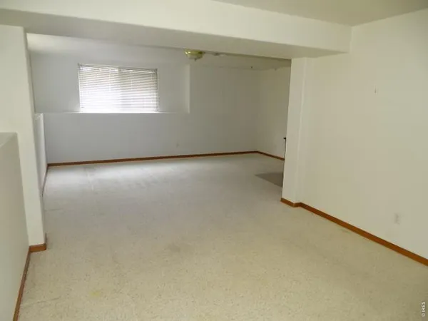an empty room with a empty space and windows
