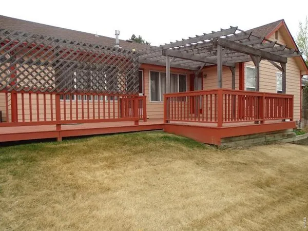 a view of a house with wooden fence