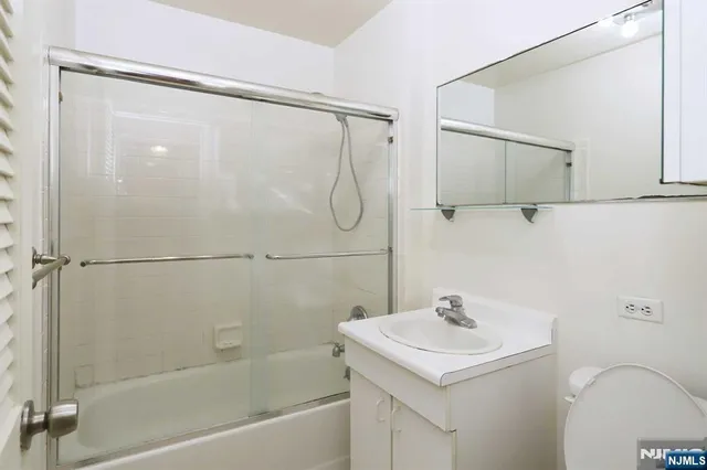 a bathroom with a sink a mirror and a shower