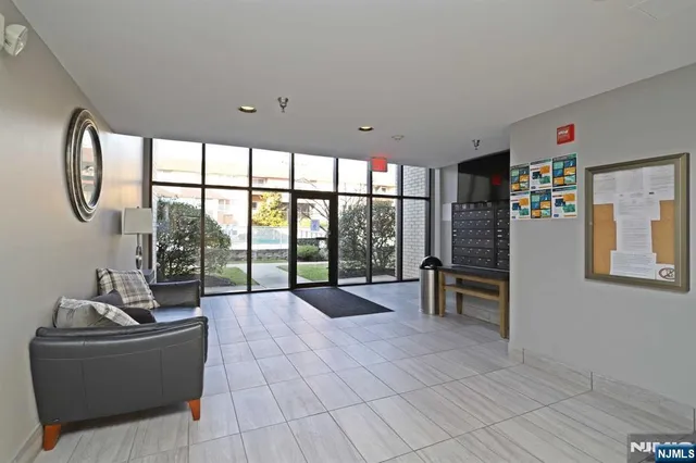 a living room with furniture large window and flat screen tv