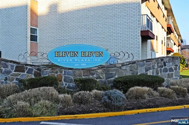 a view of a street with potted plants and brick walls