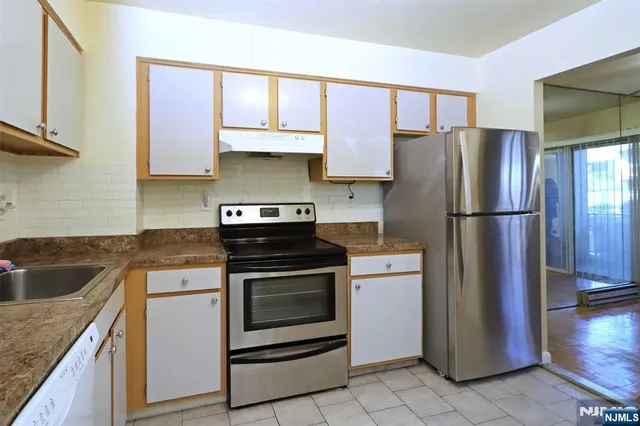 a kitchen with a stove refrigerator and microwave