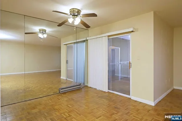a view of a room with a ceiling fan