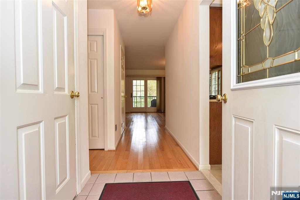 a view of a hallway with wooden floor and entryway