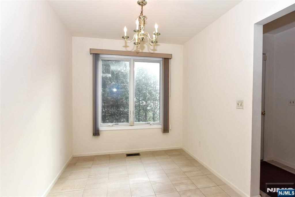 339 Cambridge Drive Ramsey, NJ 07446 - Photo 11 of 26 a view of an empty room with a window