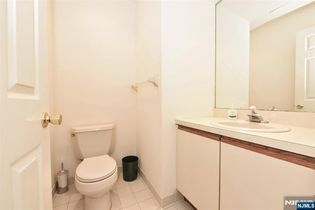 339 Cambridge Drive Ramsey, NJ 07446 - Photo 12 of 26 a bathroom with a toilet sink and mirror