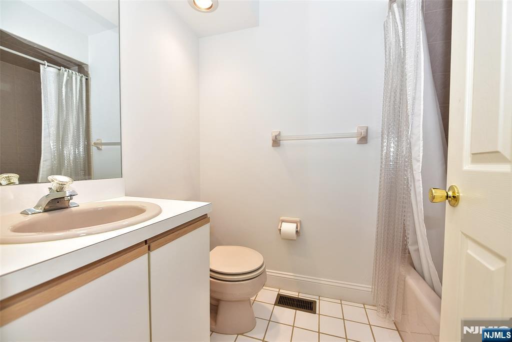 339 Cambridge Drive Ramsey, NJ 07446 - Photo 18 of 26 a bathroom with a granite countertop sink toilet and shower