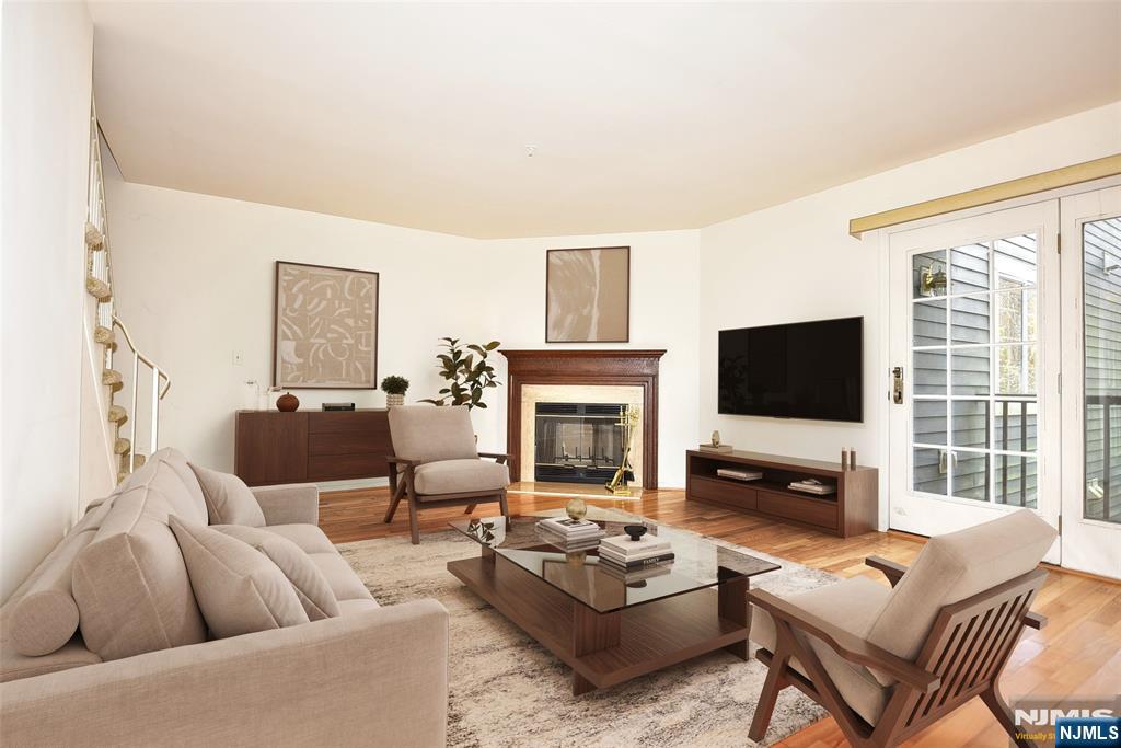 339 Cambridge Drive Ramsey, NJ 07446 - Photo 4 of 26 a living room with furniture a fireplace and a flat screen tv