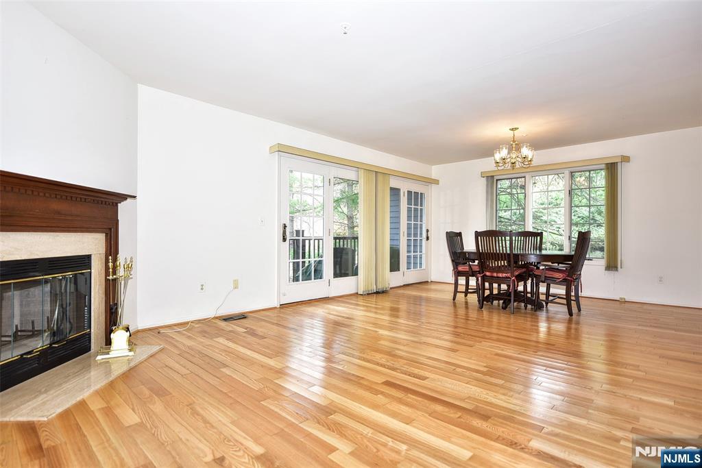 339 Cambridge Drive Ramsey, NJ 07446 - Photo 6 of 26 a view of a dining room with furniture and chandelier