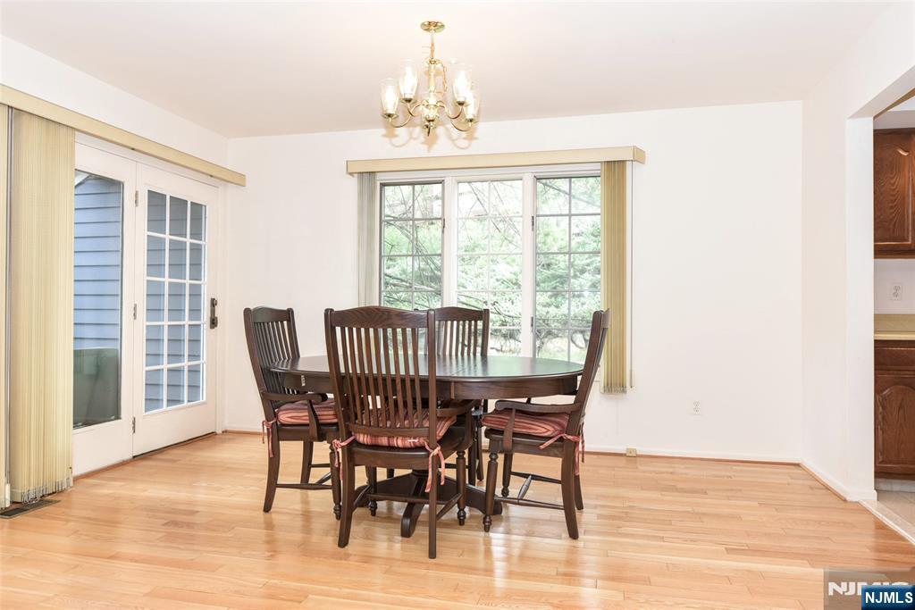 339 Cambridge Drive Ramsey, NJ 07446 - Photo 7 of 26 a view of a dining room with furniture wooden floor and chandelier
