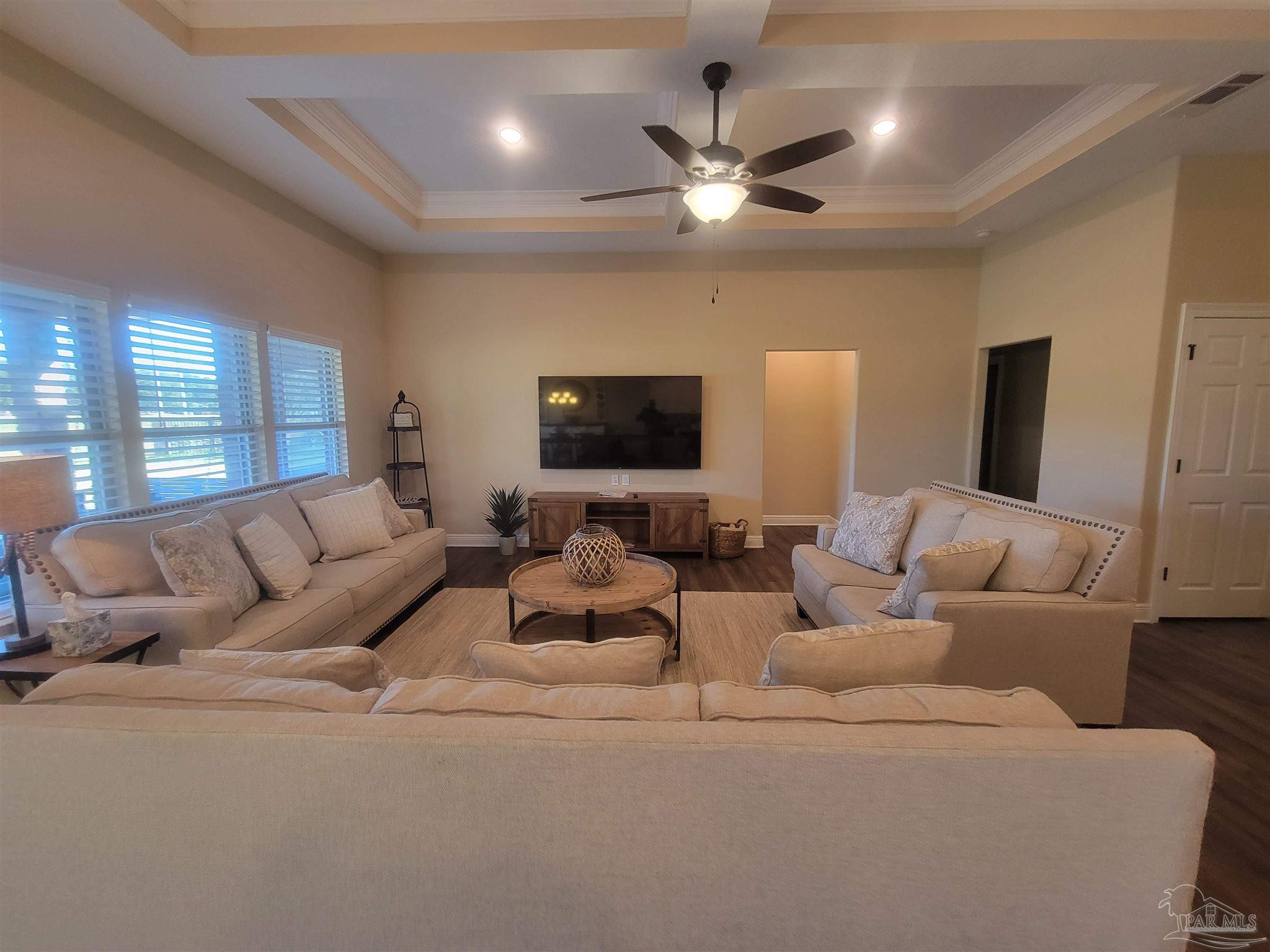 7381 Old Bay Pointe Road Milton, FL 32583 - Photo 2 of 8 a living room with furniture and a flat screen tv
