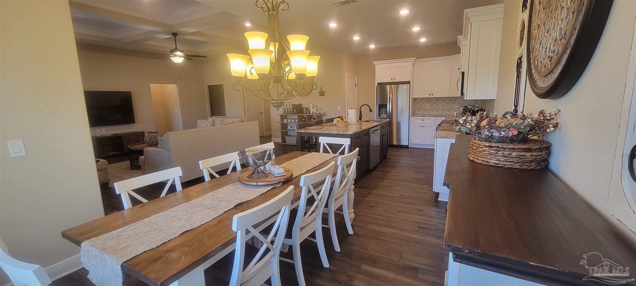 7381 Old Bay Pointe Road Milton, FL 32583 - Photo 4 of 8 a view of a dining room with furniture and wooden floor
