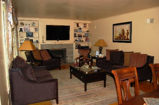 826 South Seminary Avenue Park Ridge, IL 60068 - Photo 4 of 12 a living room with furniture a flat screen tv and a fireplace