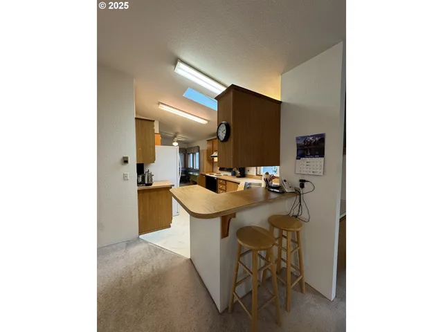 a room with a sink and chairs