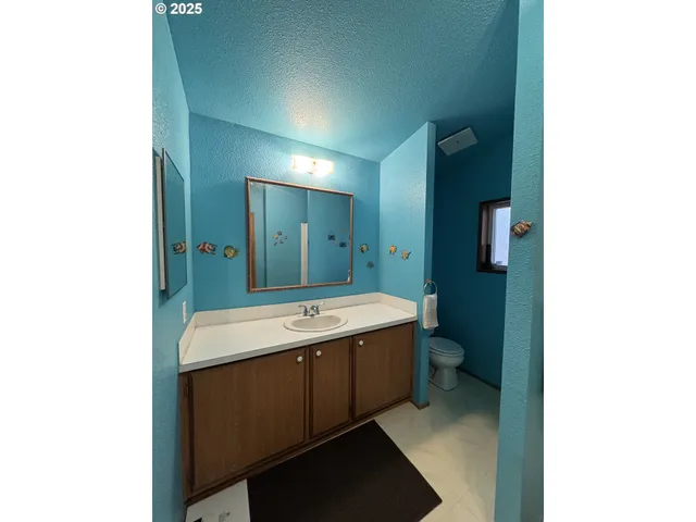 a view of a bathroom with a sink and mirror
