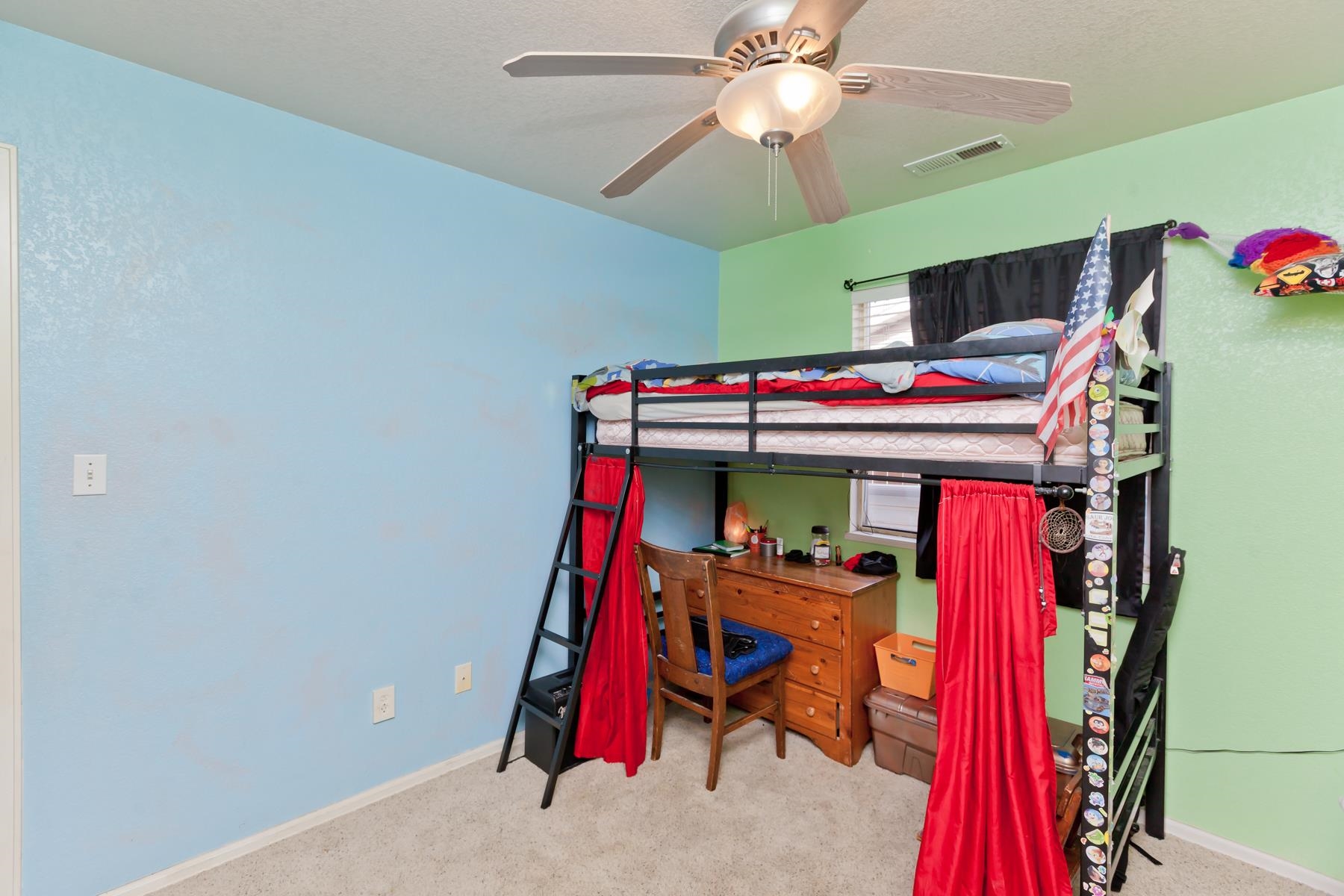 231 Narrow Leaf Drive Fruita, CO 81521 - Photo 16 of 40 a bed room with a bed and a chandelier
