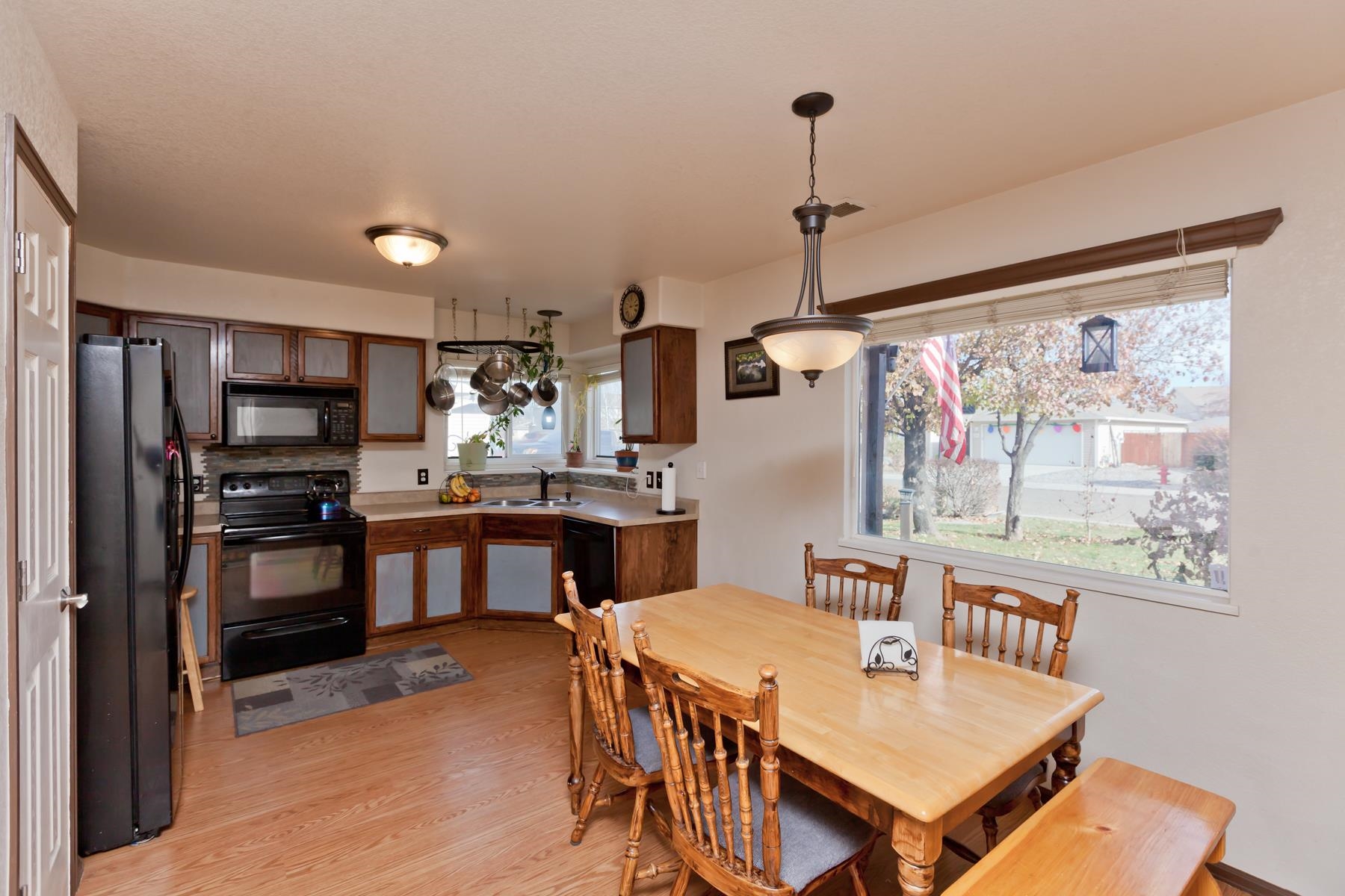 231 Narrow Leaf Drive Fruita, CO 81521 - Photo 17 of 40 a kitchen with stainless steel appliances granite countertop a refrigerator a stove top oven a sink dishwasher and white cabinets with wooden floor