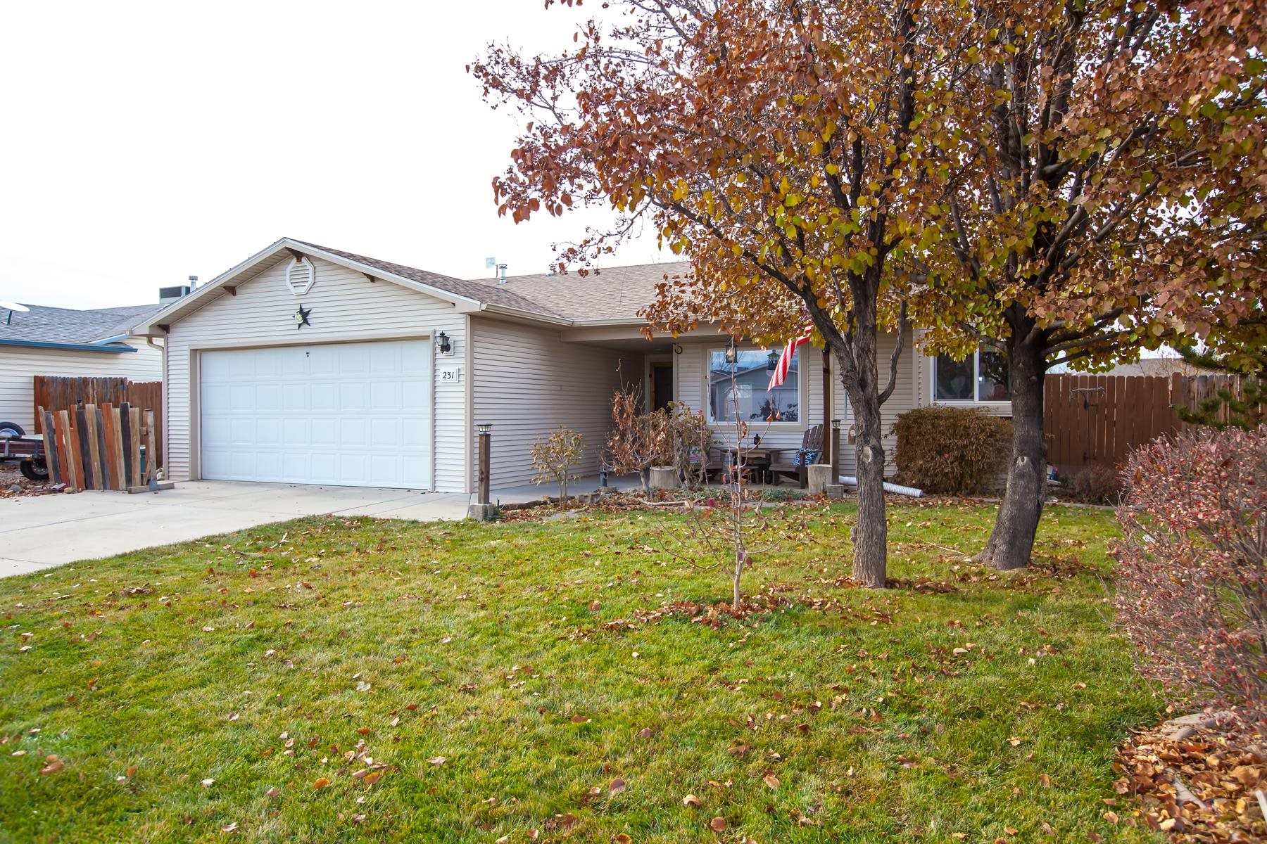 231 Narrow Leaf Drive Fruita, CO 81521 - Photo 2 of 40 a backyard of a house with table and chairs