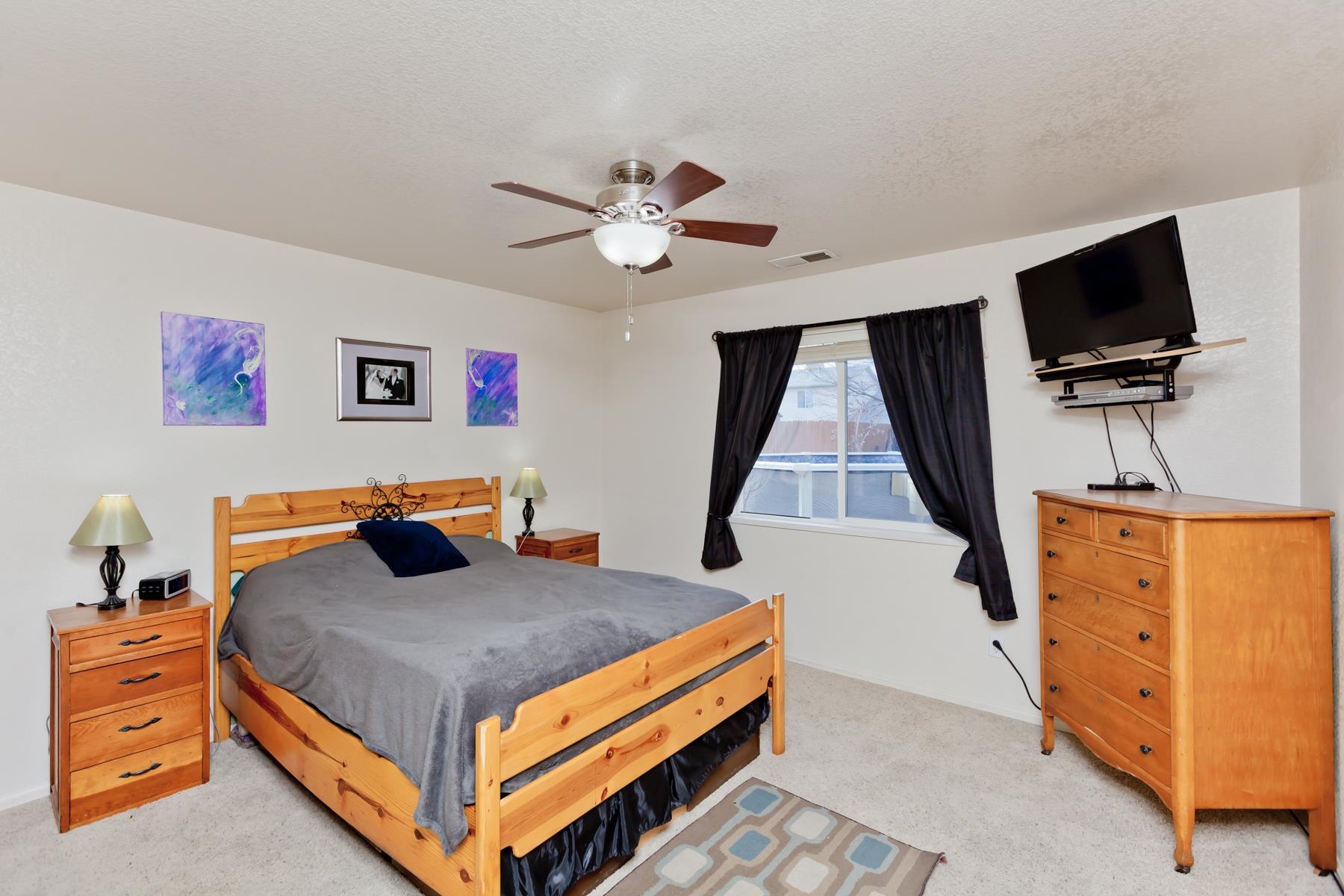 231 Narrow Leaf Drive Fruita, CO 81521 - Photo 21 of 40 a bedroom with a bed and flat screen tv