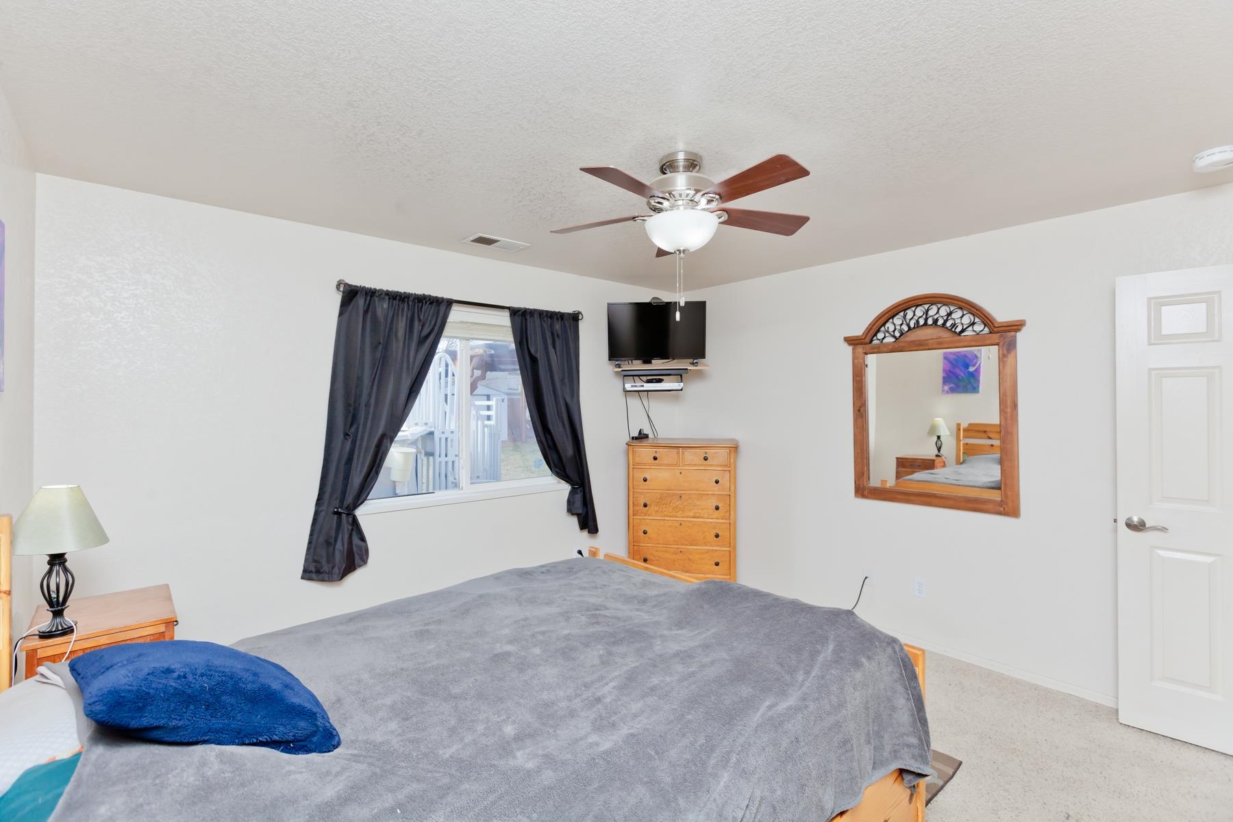 231 Narrow Leaf Drive Fruita, CO 81521 - Photo 22 of 40 a bedroom with a bed and a chandelier
