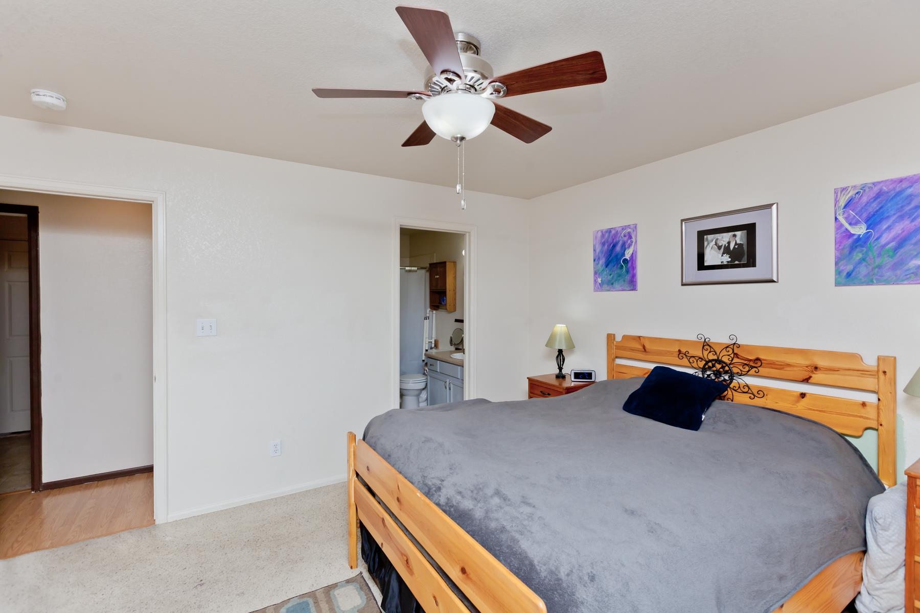 231 Narrow Leaf Drive Fruita, CO 81521 - Photo 23 of 40 a bedroom with a bed and a chandelier